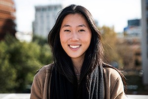 Woman with jacket smiling outside