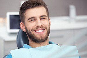 Bearded man in dental chair smiling