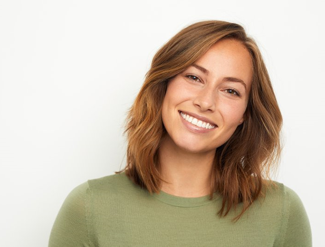 a woman with a dental bridge smiling in Westlake Hills 