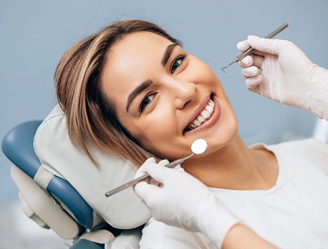 Woman smiling in chair of cosmetic dentist in Westlake Hills