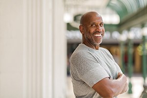 Man smiles confidently after paying for cosmetic dentistry in West Lake Hills