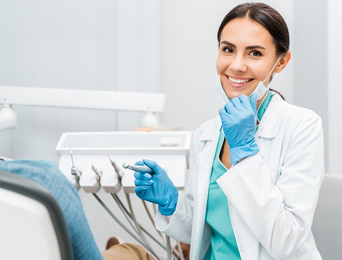 smiling dentist with mask pulled down