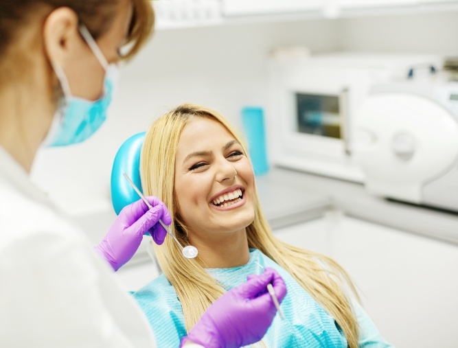 Woman in dental chair for checkup to prevent dental emergencies