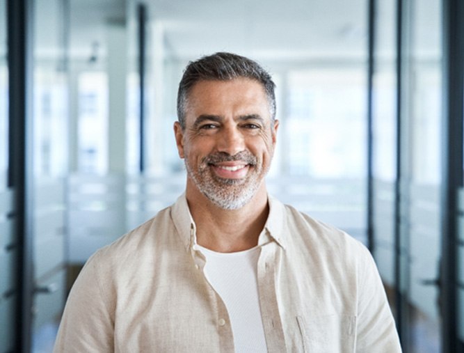 smiling middle-aged many with short gray beard 