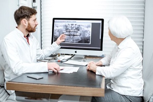 implant dentist in Westlake showing a patient their X-rays