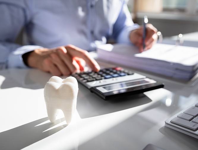 Man calculating dental insurance coverage