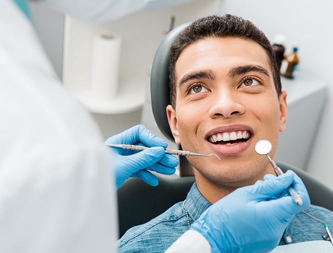 Man smiling at dentist from dental chair