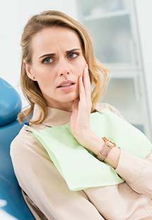 Woman talking to dentist about tooth pain