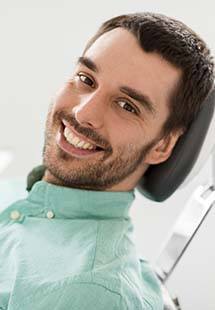 Man smiling while getting a dental checkup