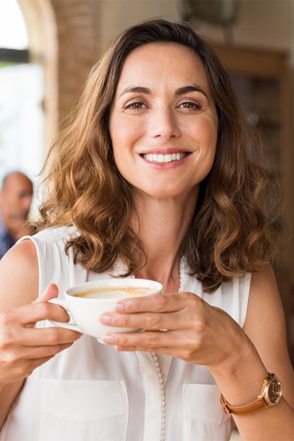 Woman sharing healthy smile after preventive dentistry