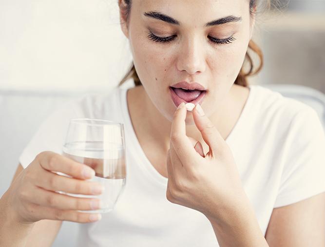 Woman taking oral conscious dental sedation pill
