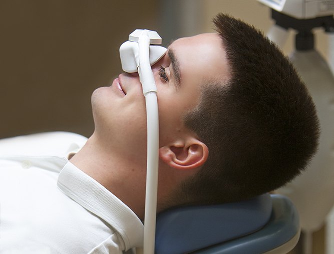 Man with nitrous oxide dental sedation maks in place