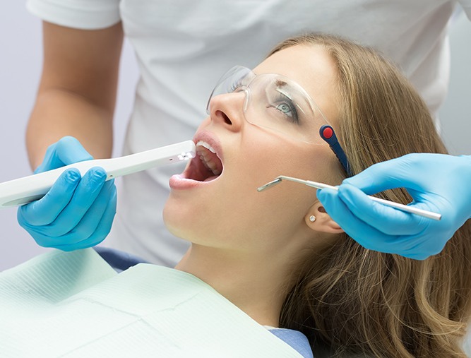 Dentist using intraoral camera to capture smile images