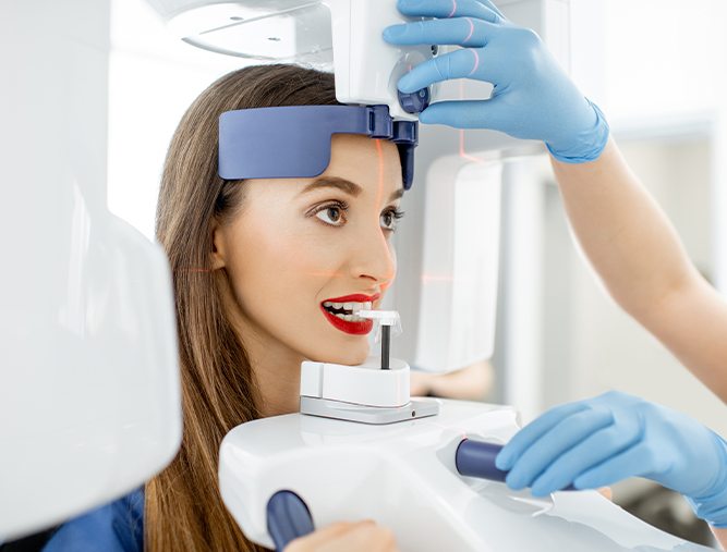 woman being scanned by panoramic xray machine