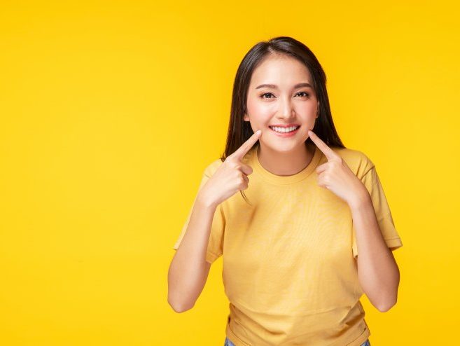 person pointing to their dental implants