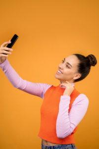 Smiling woman taking selfie