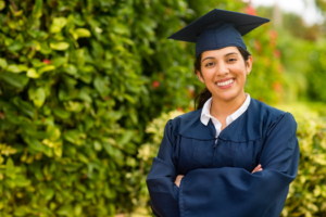 a student wearing a cap and gown for their graduation