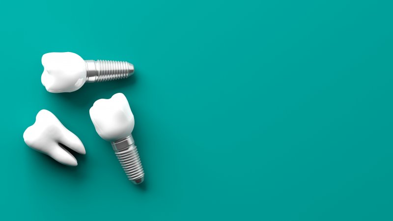 Dental implants on turquoise background