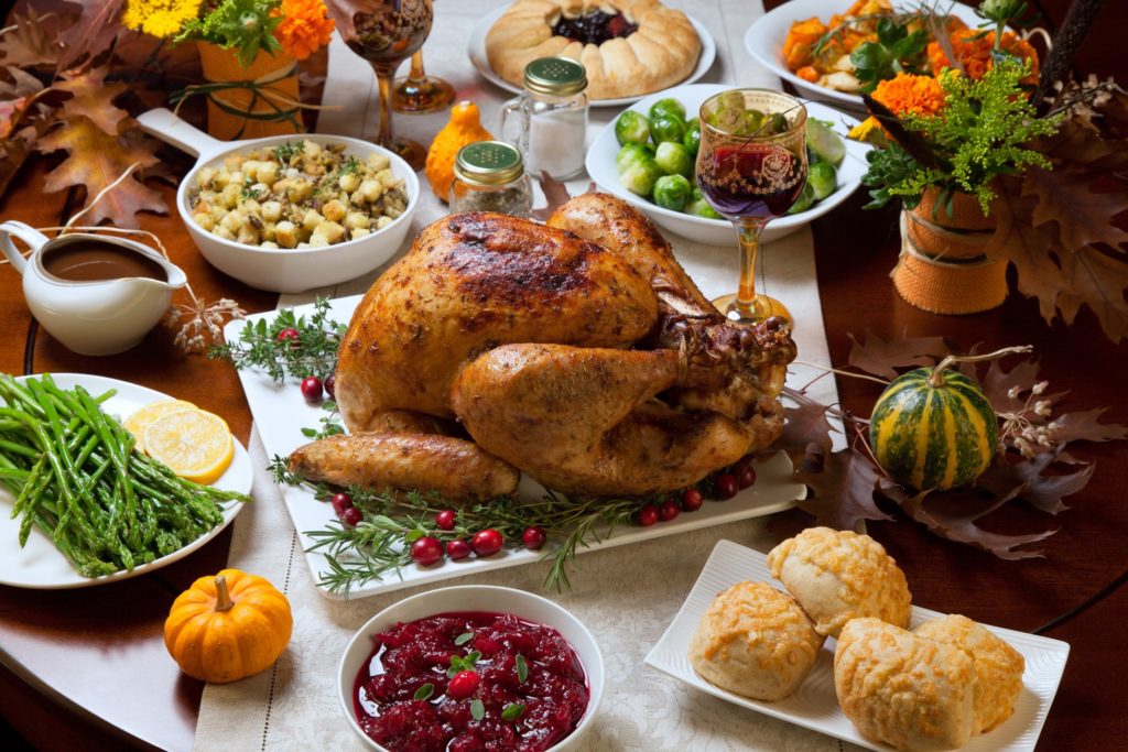 Side dishes surrounding turkey on Thanksgiving table