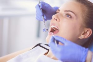 Woman with blue eyes in dentist's chair having an examination